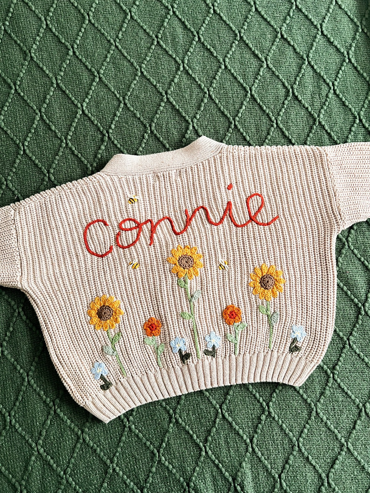 Beige handknitted jumper and the word Connie