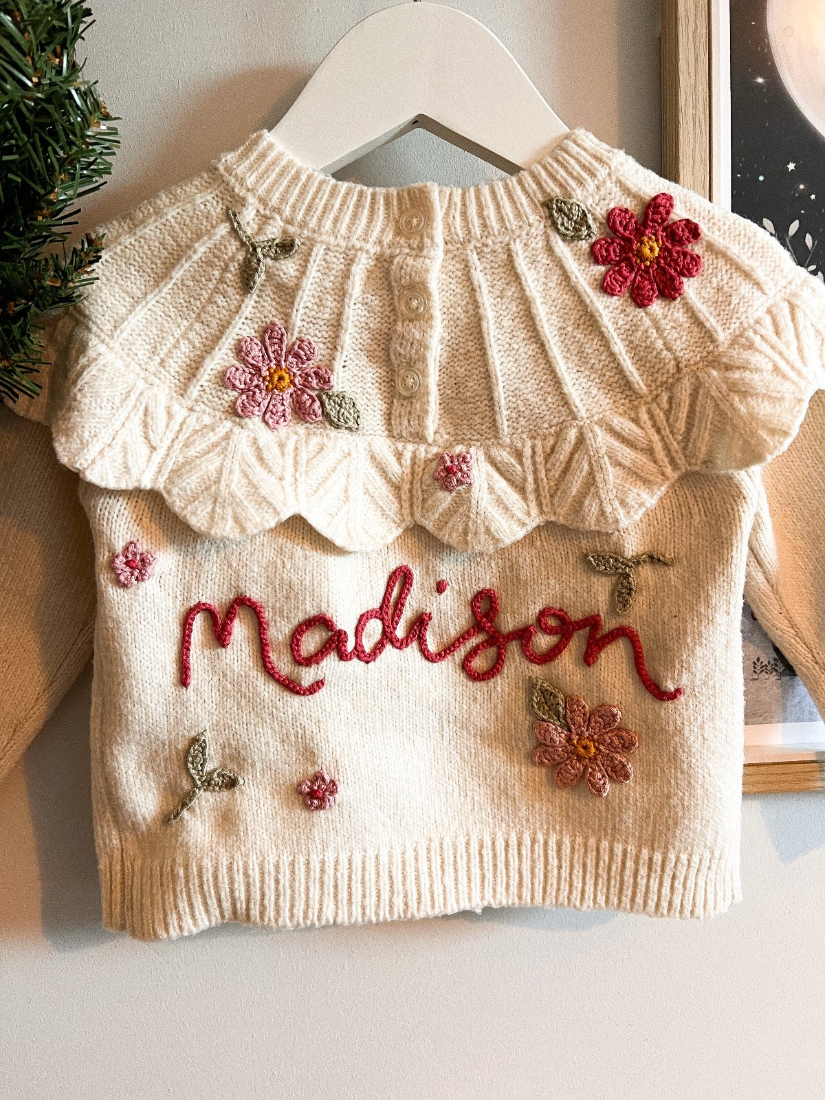 White handknitted jumper with the word Maddison