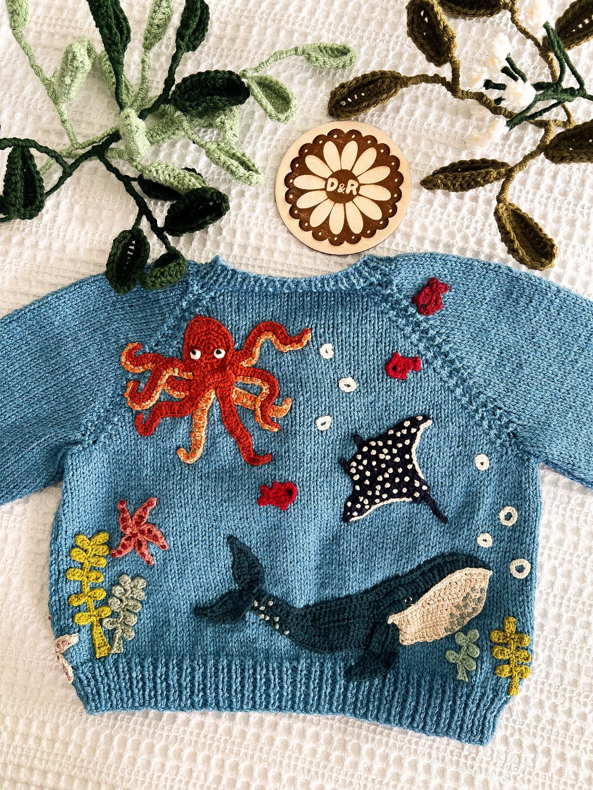 Blue handknitted cardigan with sea creatures