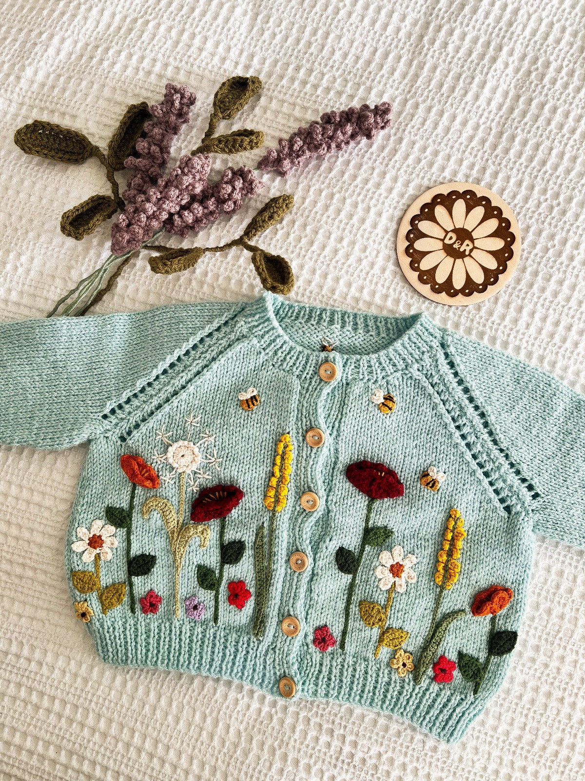 light blue cardigan with crochet wild flowers